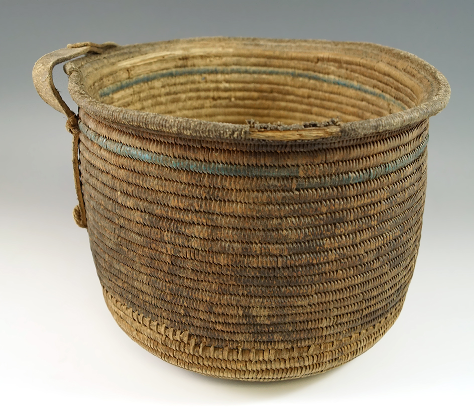 Tightly woven 5 1/2" tall x 5 1/2" wide African woven Basket with a leather strap handle.