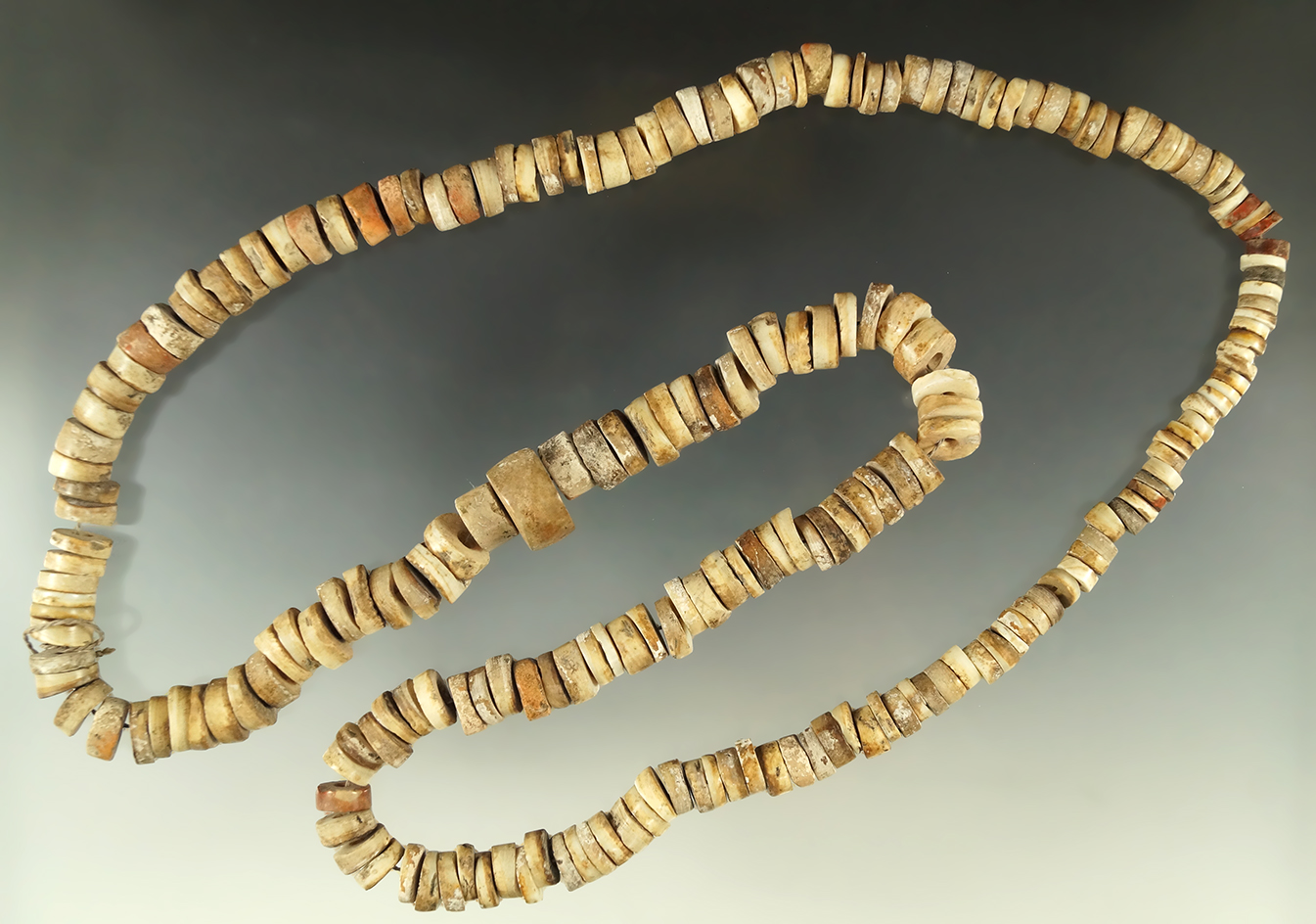 Large 36" strand of drilled shell and stone beads from the Howard Jerle collection.