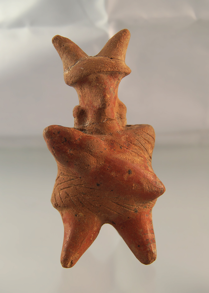 4 9/16" pre-Columbian figurine found in Mexico. Two pieces on the headgear have been reglued.
