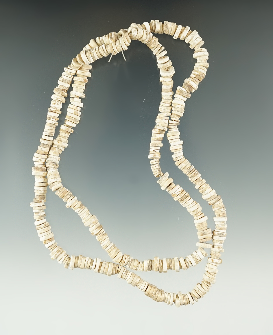 21" Long strand of well patinated drilled shell beads.