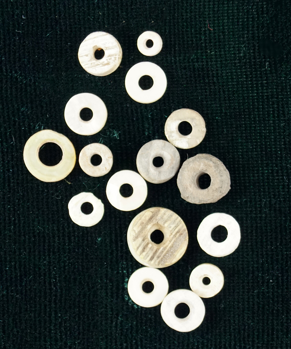 Nice group of 16 drilled stone and bone beads found at a site in Utah.