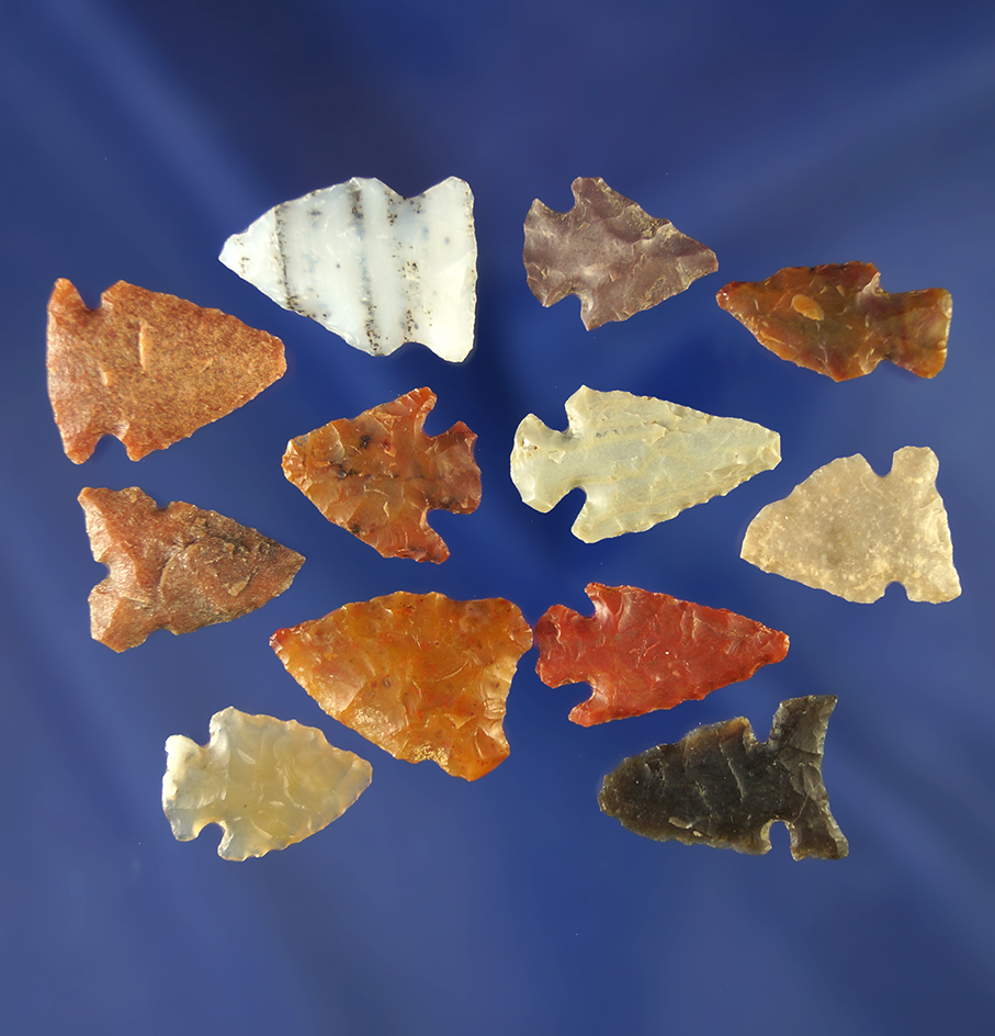12 assorted arrowheads in various conditions made from a variety of materials, Wyoming.