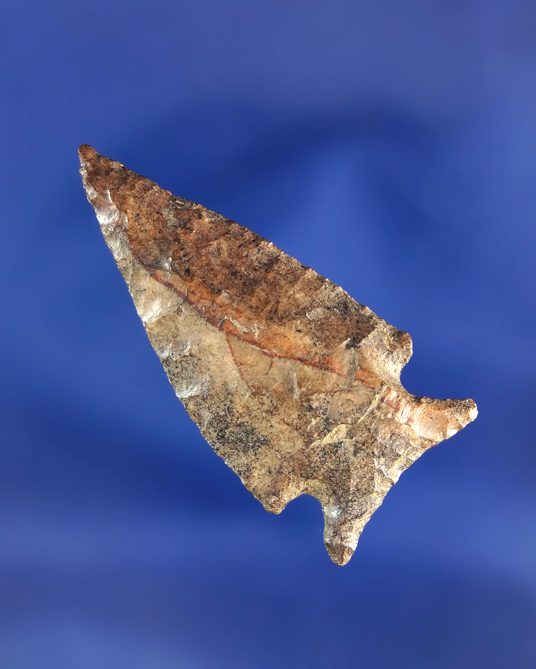 1 9/16" Snake River Dart point made from beautiful heavily patinated multicolored material.