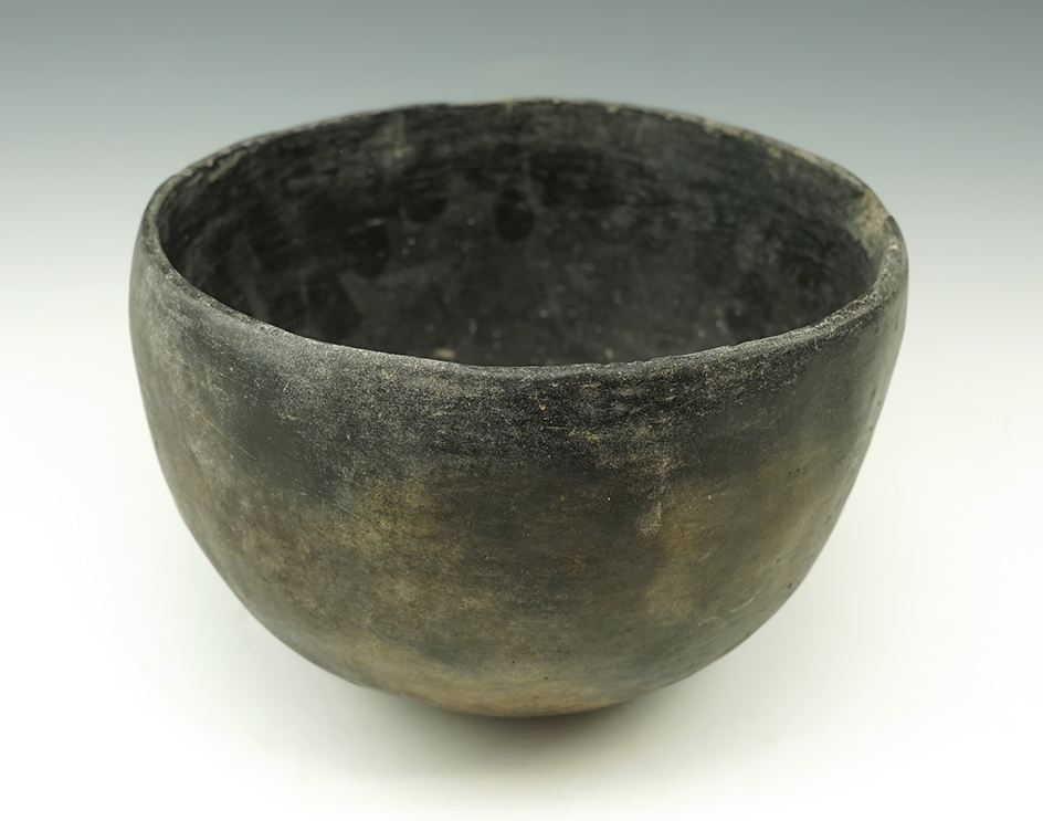 4 1/2" tall Pottery vessel - New Mexico. A couple small rim chip but overall nice condition.