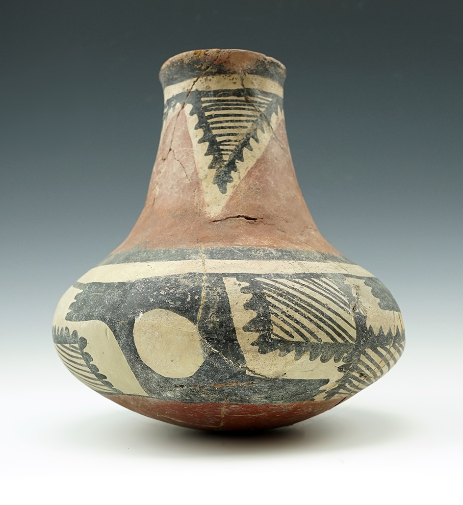 Colorful 6 3/4" tall New Mexico Pottery Vessel with many pieces glued into place.