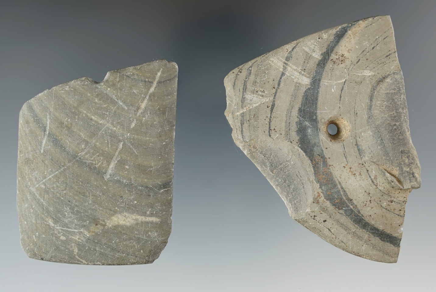 Pair of damage slate artifacts including an anciently salvaged wing bannerstone half