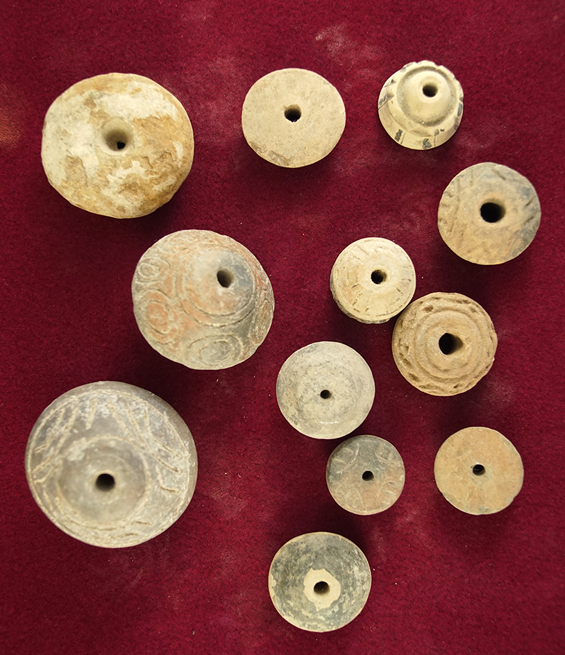 Group of 12 assorted pre-Columbian clay beads and spindle whorls found in Mexico.