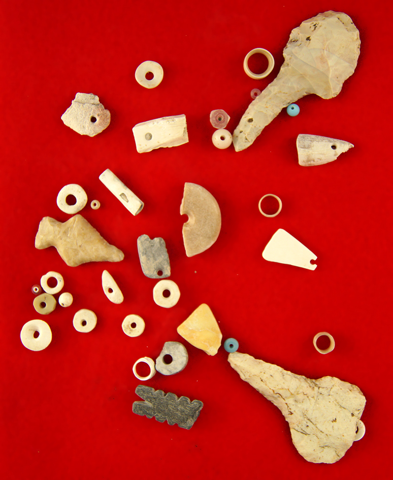 Nice assortment of flint artifacts, drilled stone, shell beads and stone fetish, largest is 2 7/16".