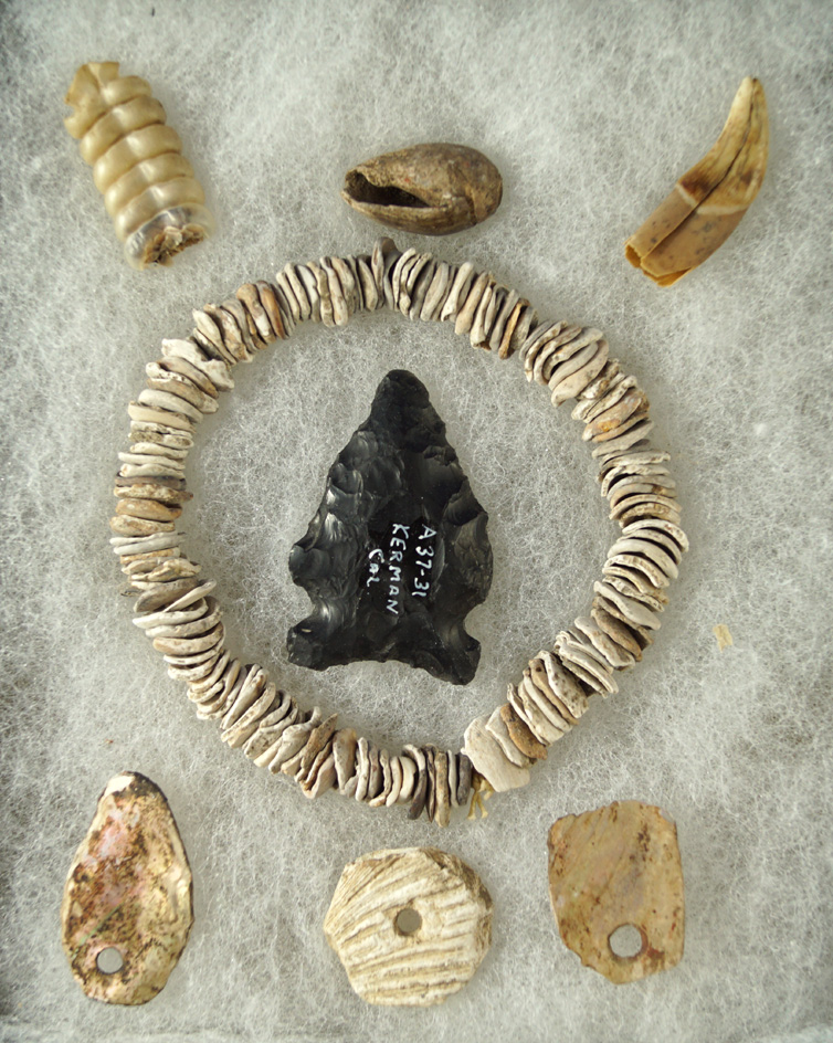 Nice group of artifacts including a 1 5/8" Sidenotch  point, assorted drilled beads and pendants