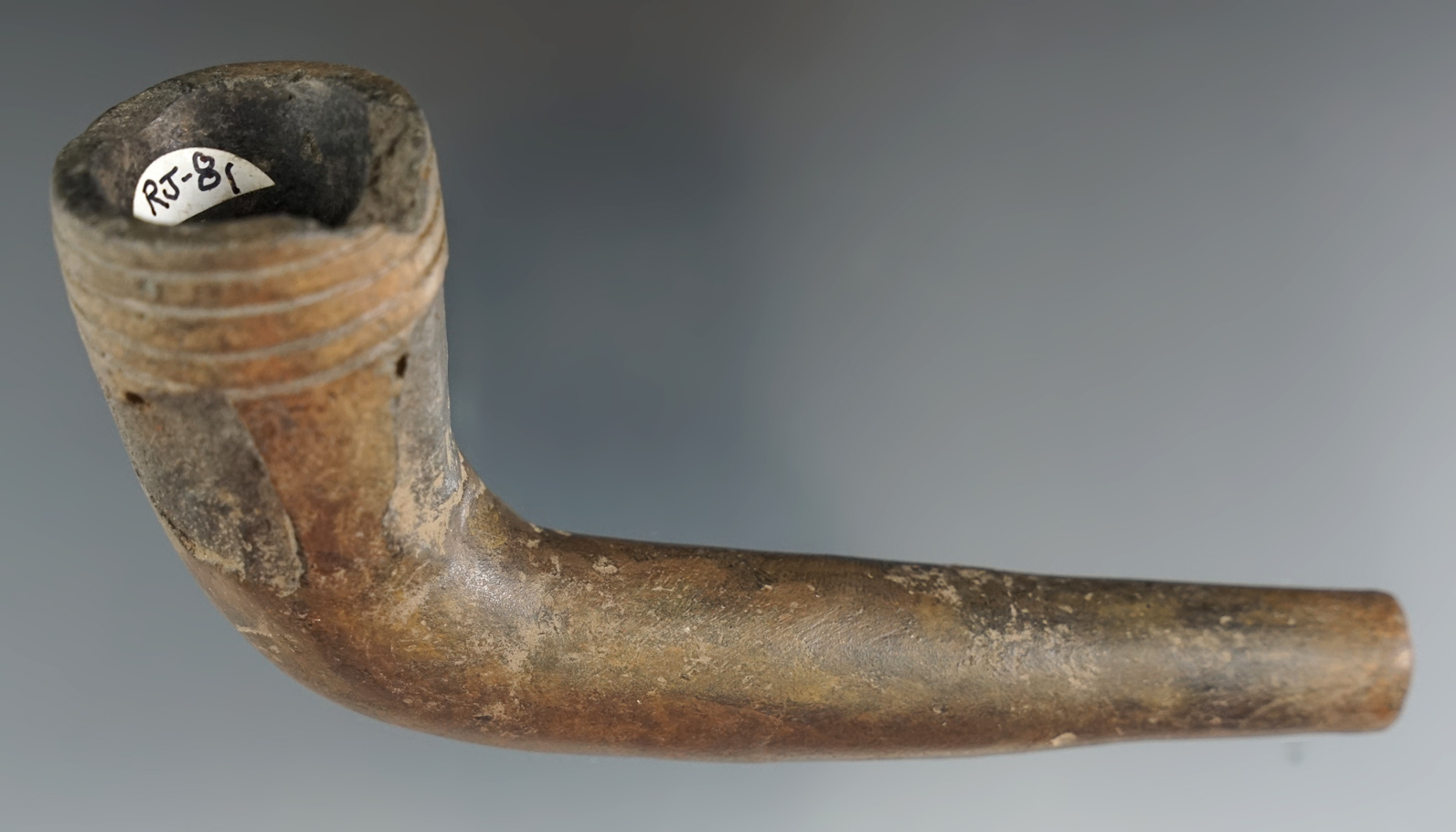 5" x 2 1/2" Iroquois clay ring bowl pipe with some damage to rim and delamination to bowl area.