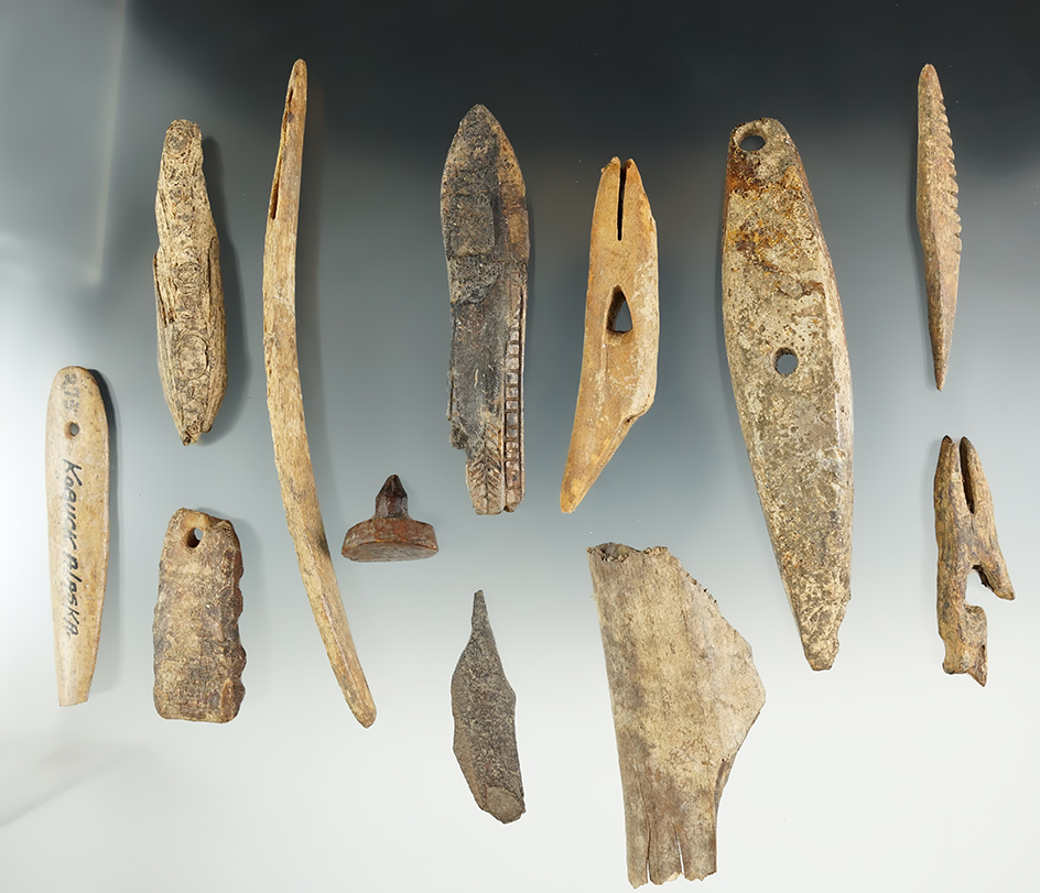 Group of assorted ivory and bone Inuit artifacts found in Alaska. Largest is 6".