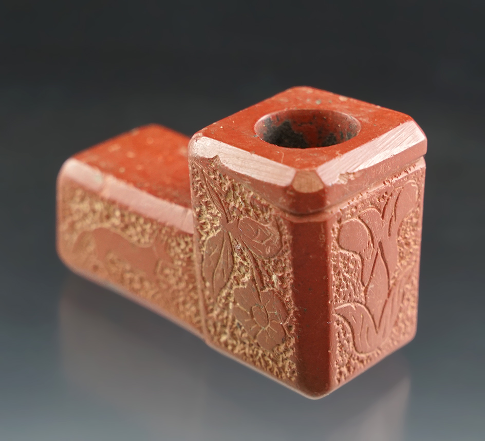 Ornately decorated 2 3/16" Catlinite pipe with a floral design carving as well as a fox.