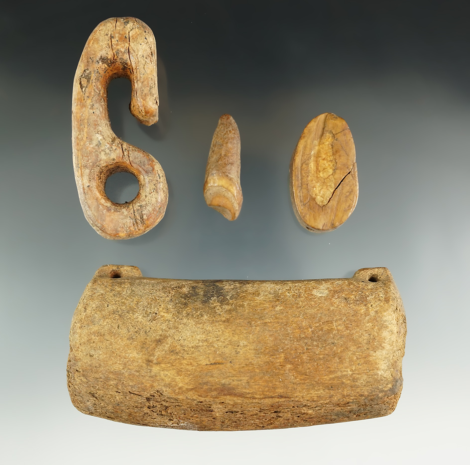 Four assorted Inuit bone artifacts found in Alaska. Largest is a 4 3/16" whalebone weight.