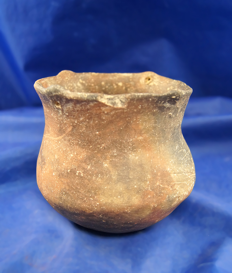 3 3/4" Tall Caddo Jar with 4 rim tabs and suspension holes that is solid.  Found in Clark Co., Arkan