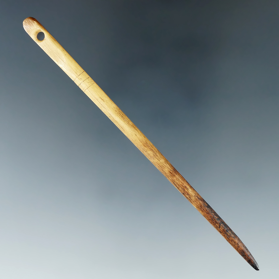 Nice! 4 1/16" perforated bone needle with three incised lines that is well patinated. Tennessee.