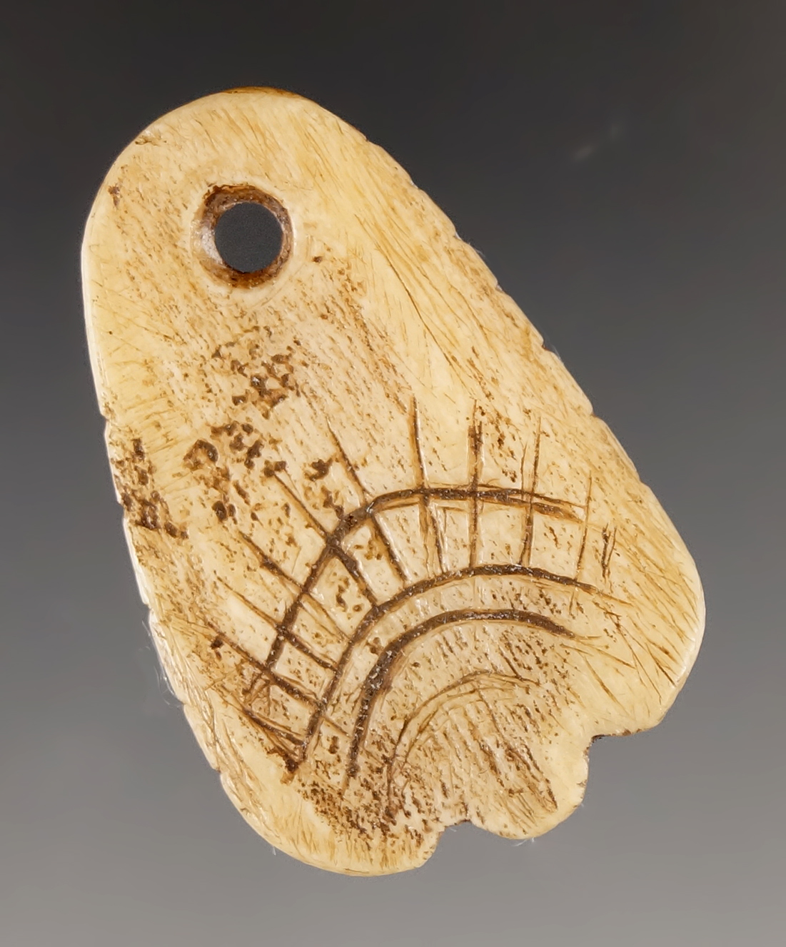 1 1/2" Bone Pendant that is engraved with tally marks. Found in Umatilla, Oregon.