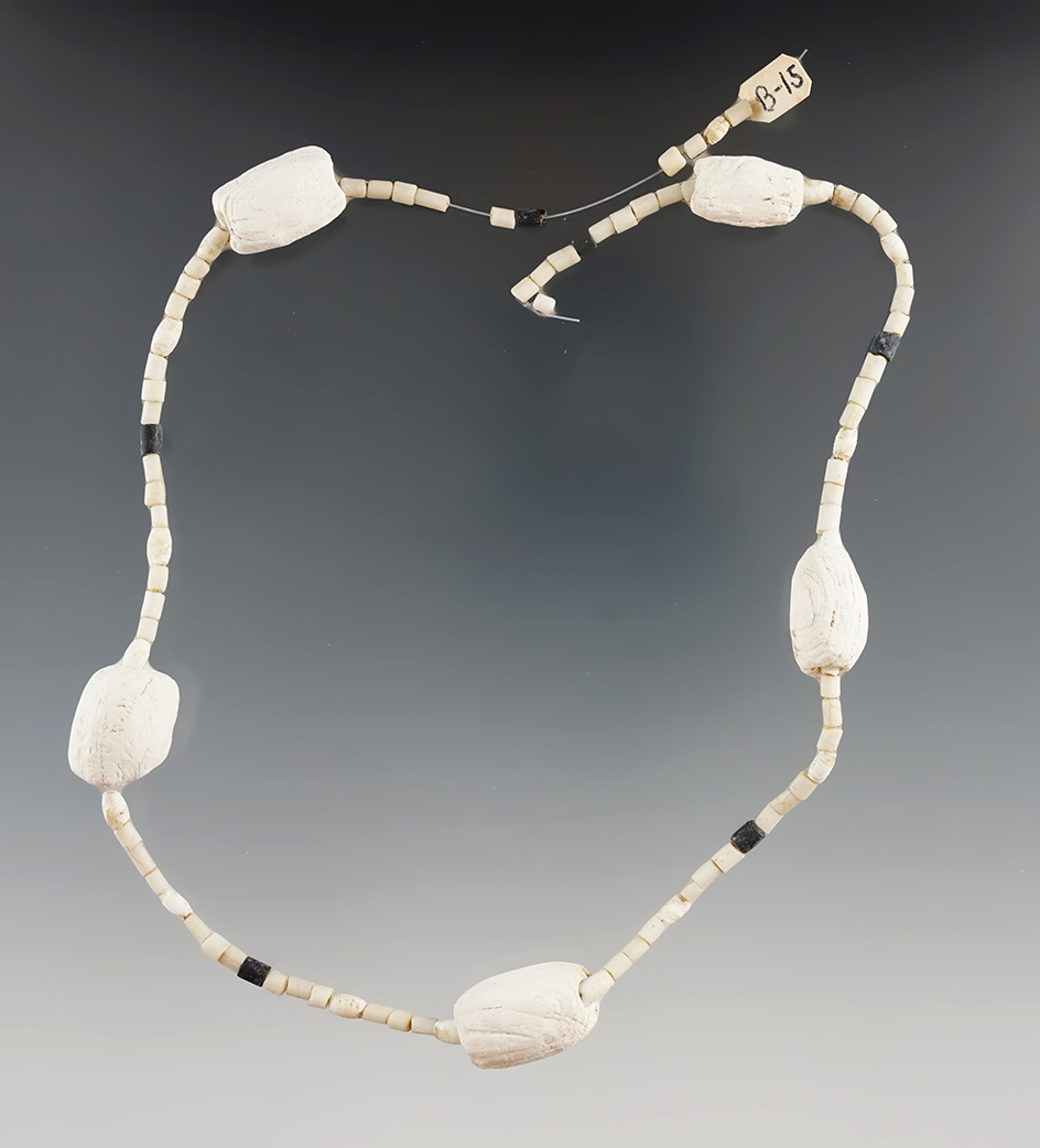 18" long strand of white and black seed beads with large shell beads found in New York.