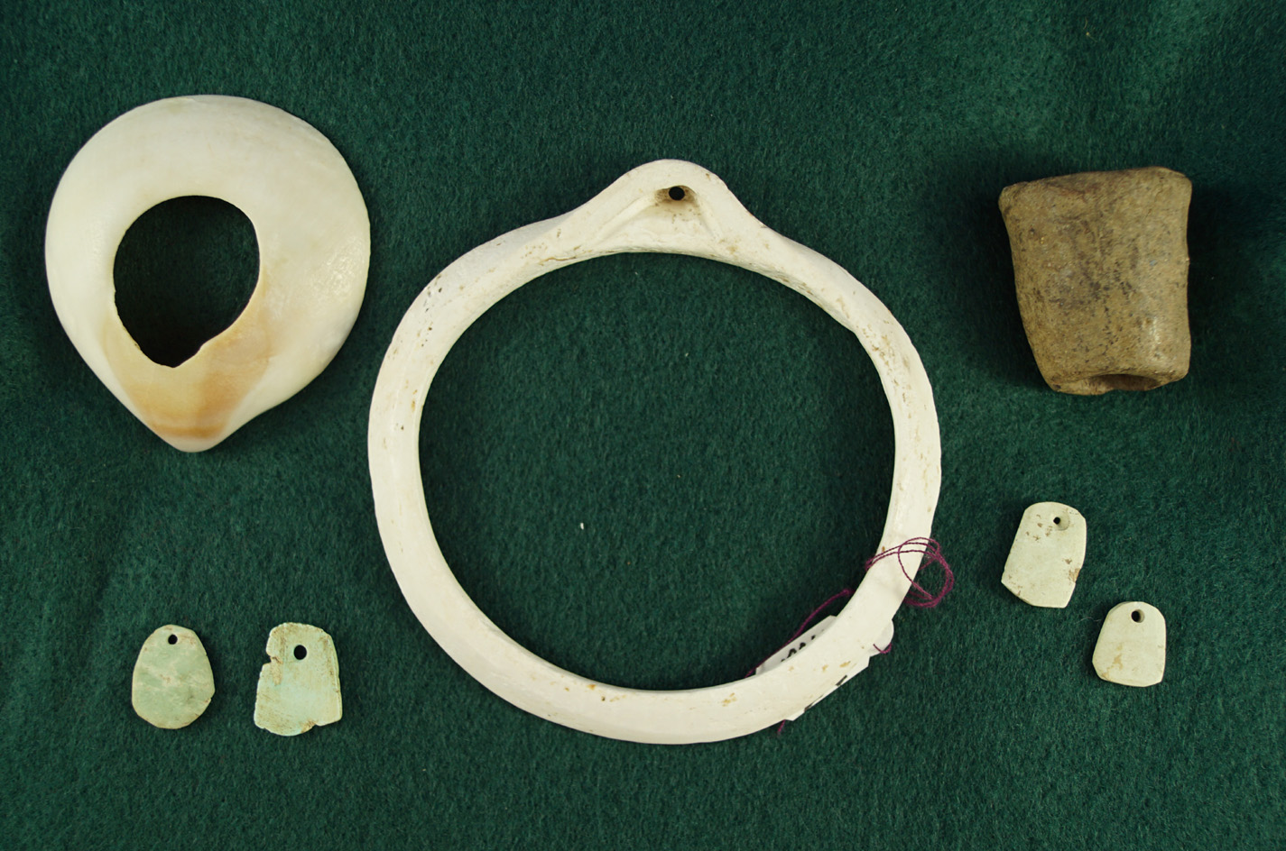 Set of assorted artifacts found in East Central Arizona including turquoise beads, shell pendant, Et