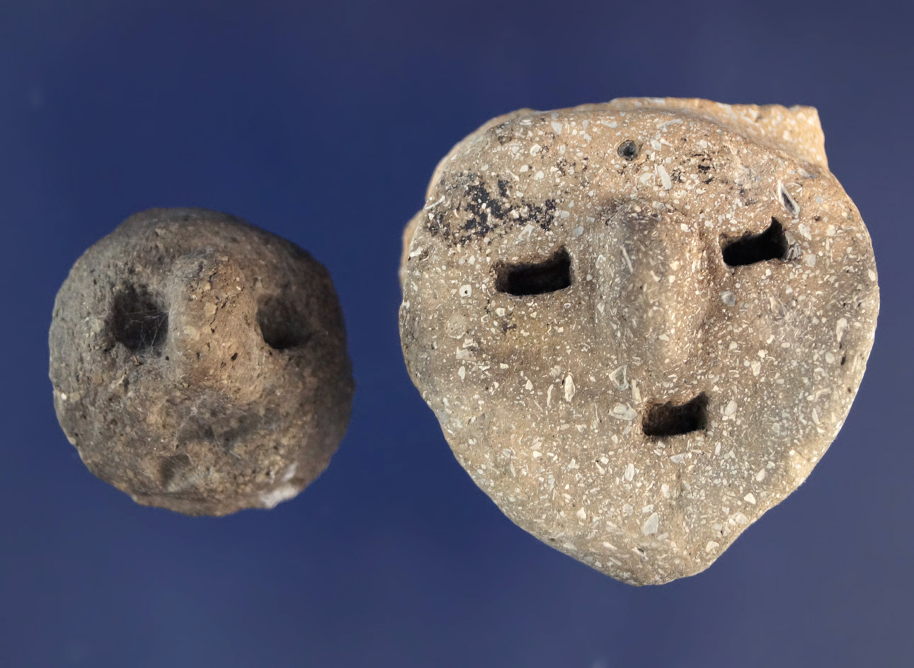 Pair of shell tempered clay pottery faces, largest is 1 1/4" found near big Lake Arkansas