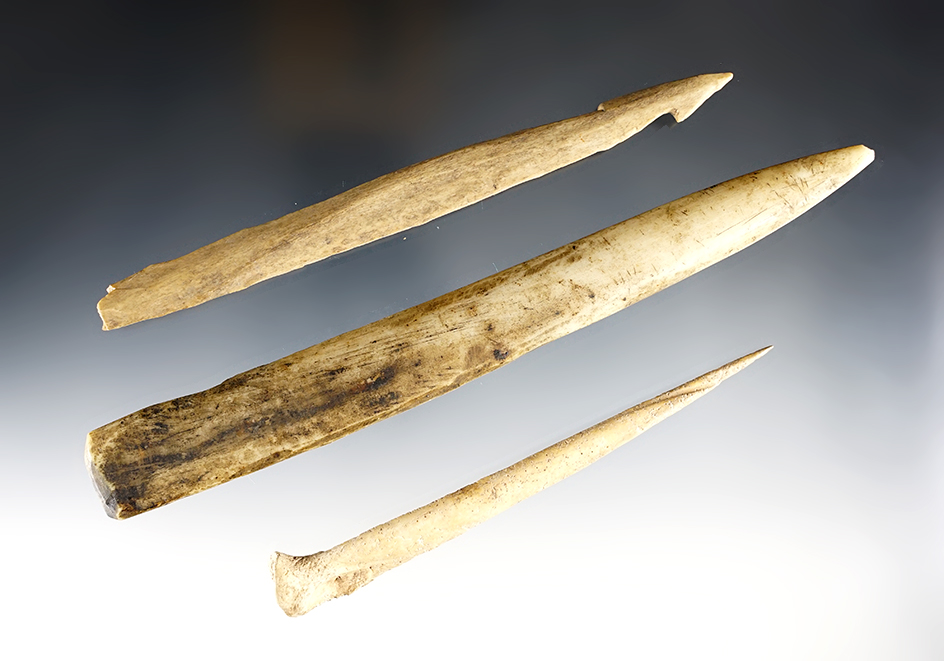 Set of three bone artifacts including a nicely styled splinter bone harpoon tip. 