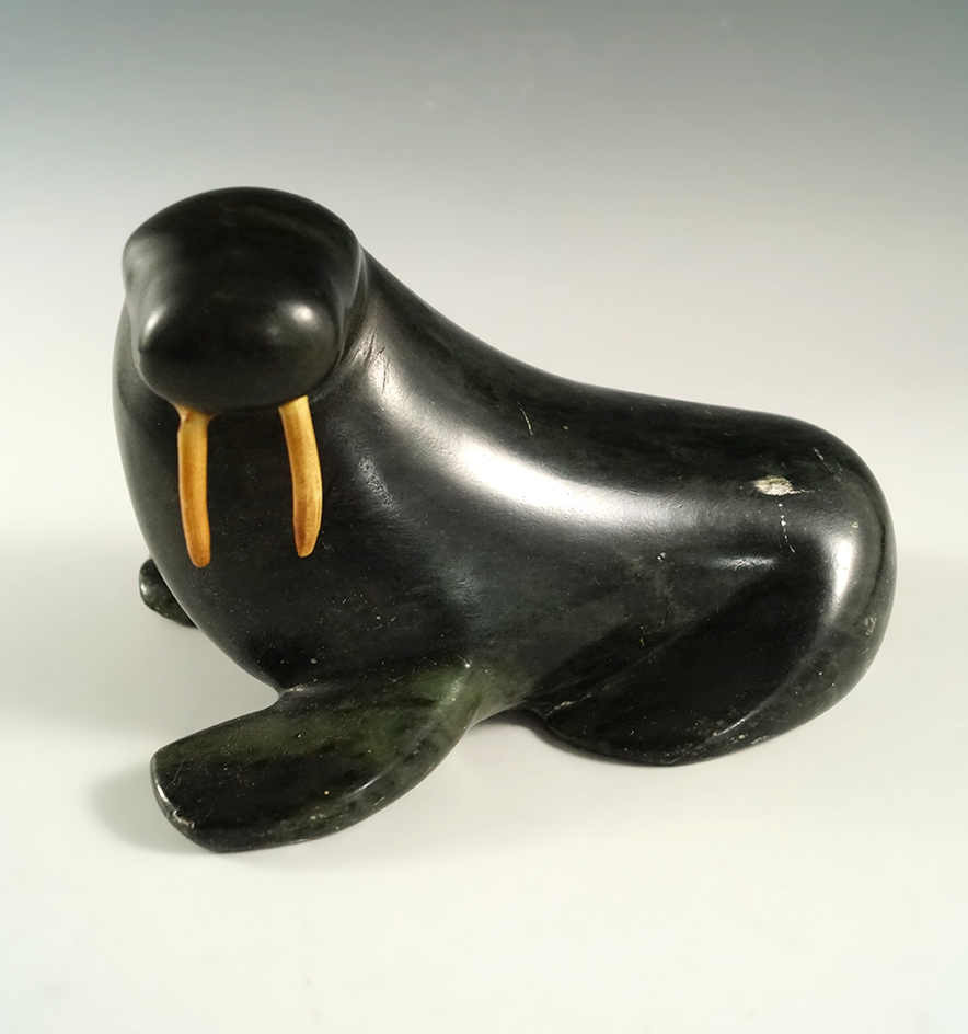 5 3/4" long Alaskan walrus carved from stone. Artist signature on base. A couple scratches on surfac
