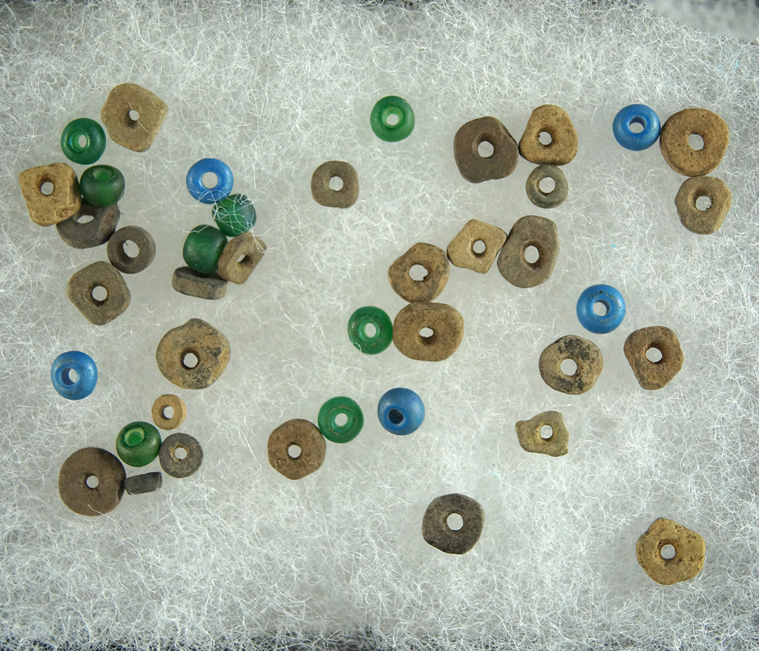 Set of small drilled stone and trade beads found at a site near the Columbia River, Washington.