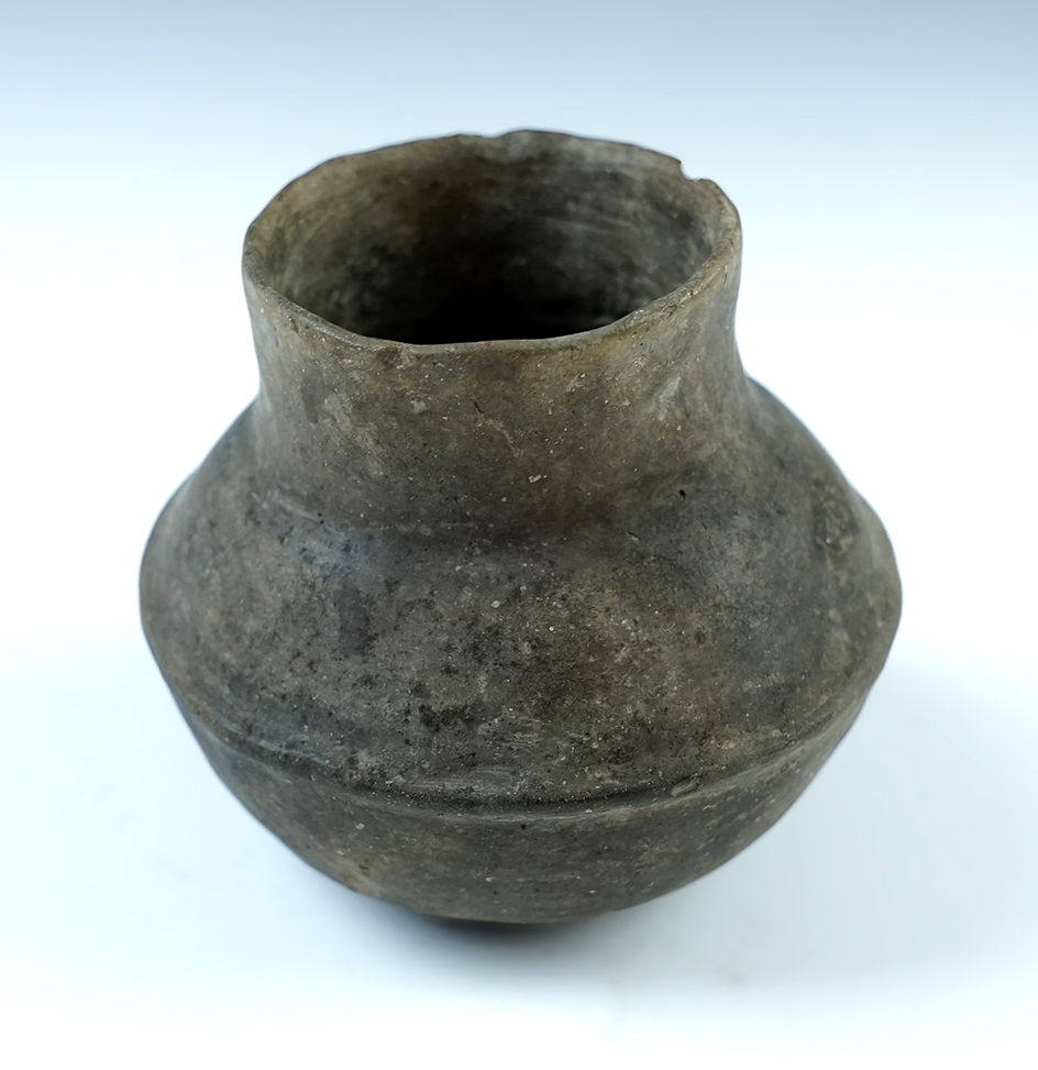 Miniature 3" tall by 3 1/2" wide Mississippian Jar. Appears solid with a couple minor chips to rim. Found in Mississippi Co., Arkansas. 
