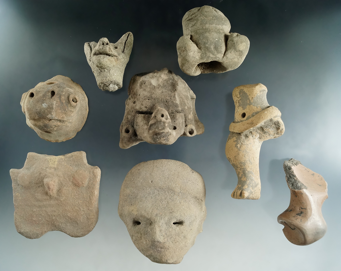 Set of eight assorted pre-Columbian pottery heads and figurines found in Mexico.