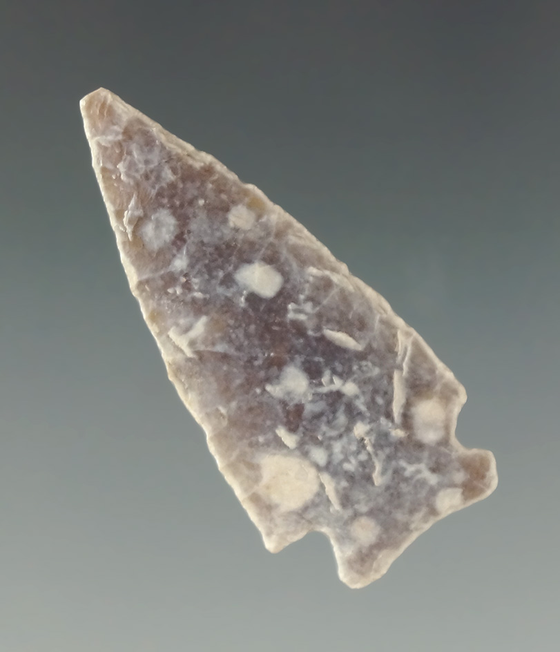 Heavily patinated 1 9/16" Knife River Flint Cornernotch found in the Dakotas.