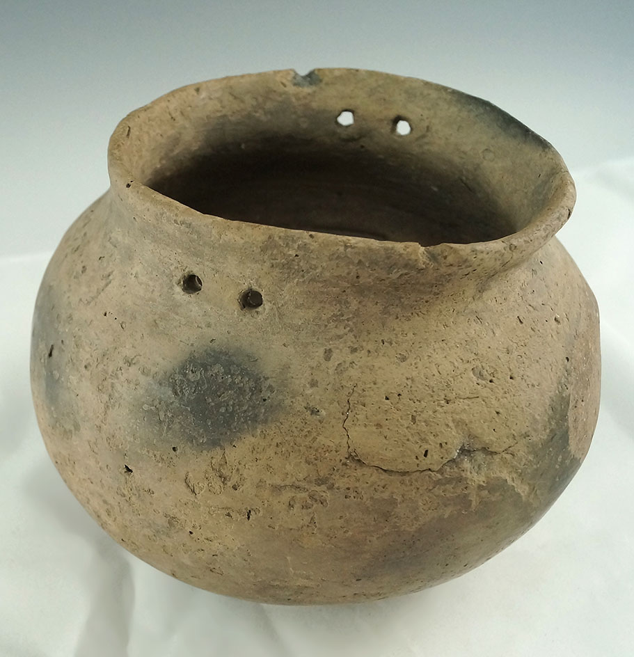 6" wide Mississippian jar with suspension holes at rim.