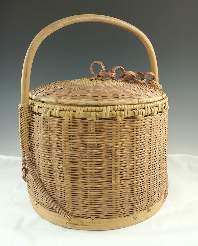 Large and very well-crafted contemporary handled Indian basket which is 14 1/2" tall.