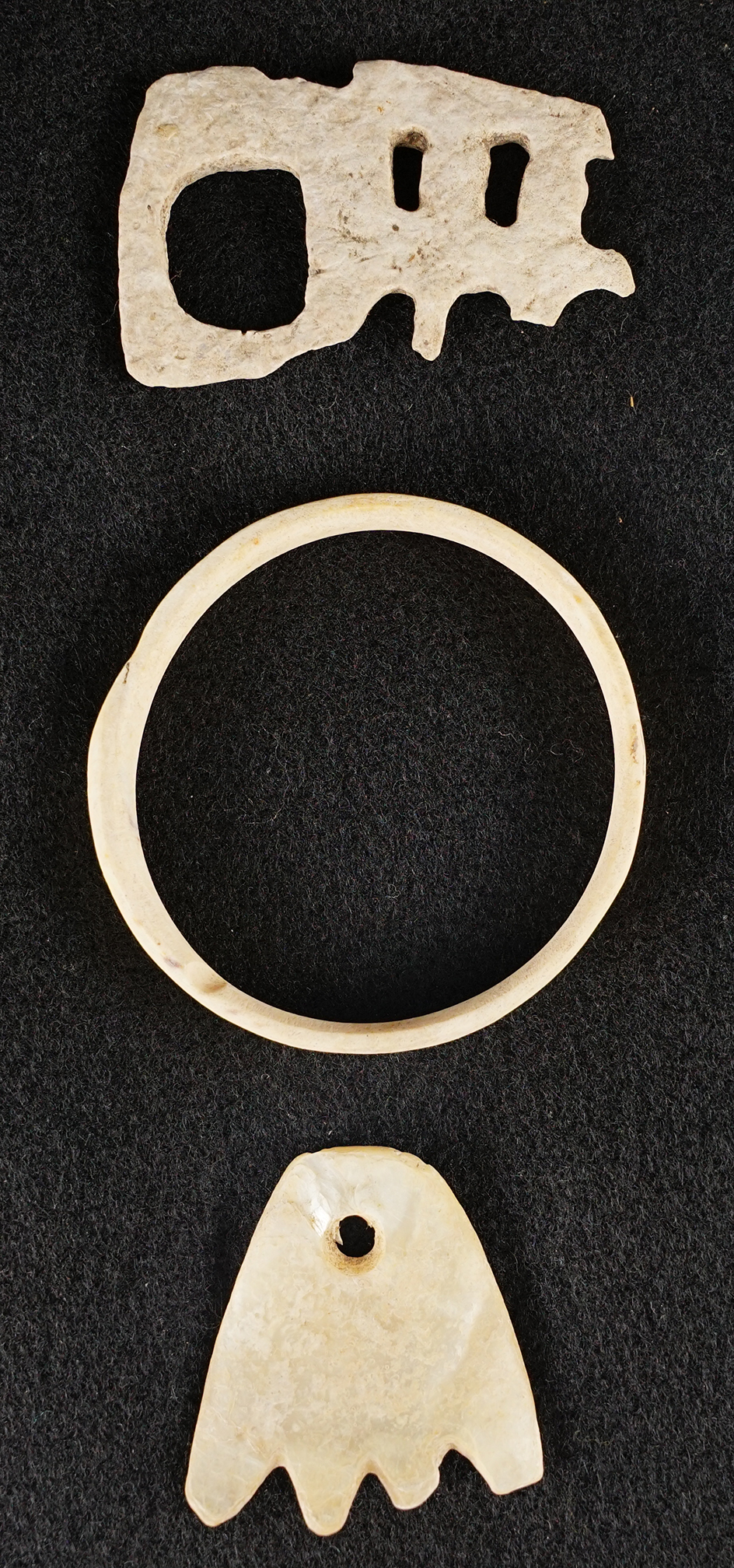 Set of three carved bone and shell ornaments circa 1880-1900. Largest is 2 1/2".