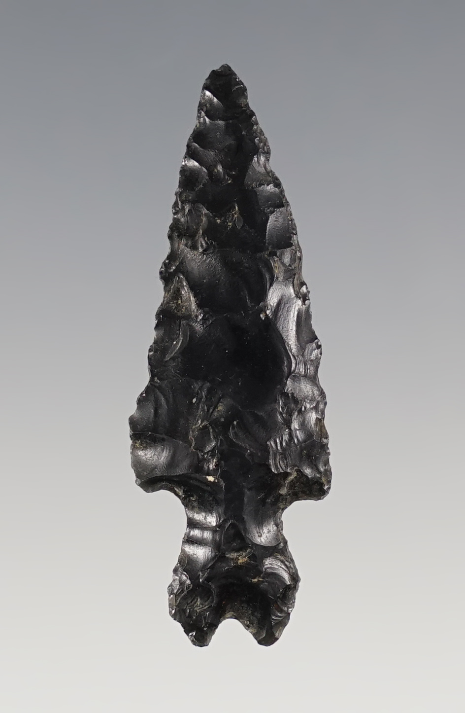 1 5/8" uniquely styled Split Stem Obsidian point found in Oregon. Ex. C.L. Pugh Museum. 