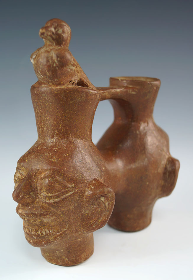 Compound style Janus Head Pot with avian effigy on top of one head - Late Moche style. Peru.