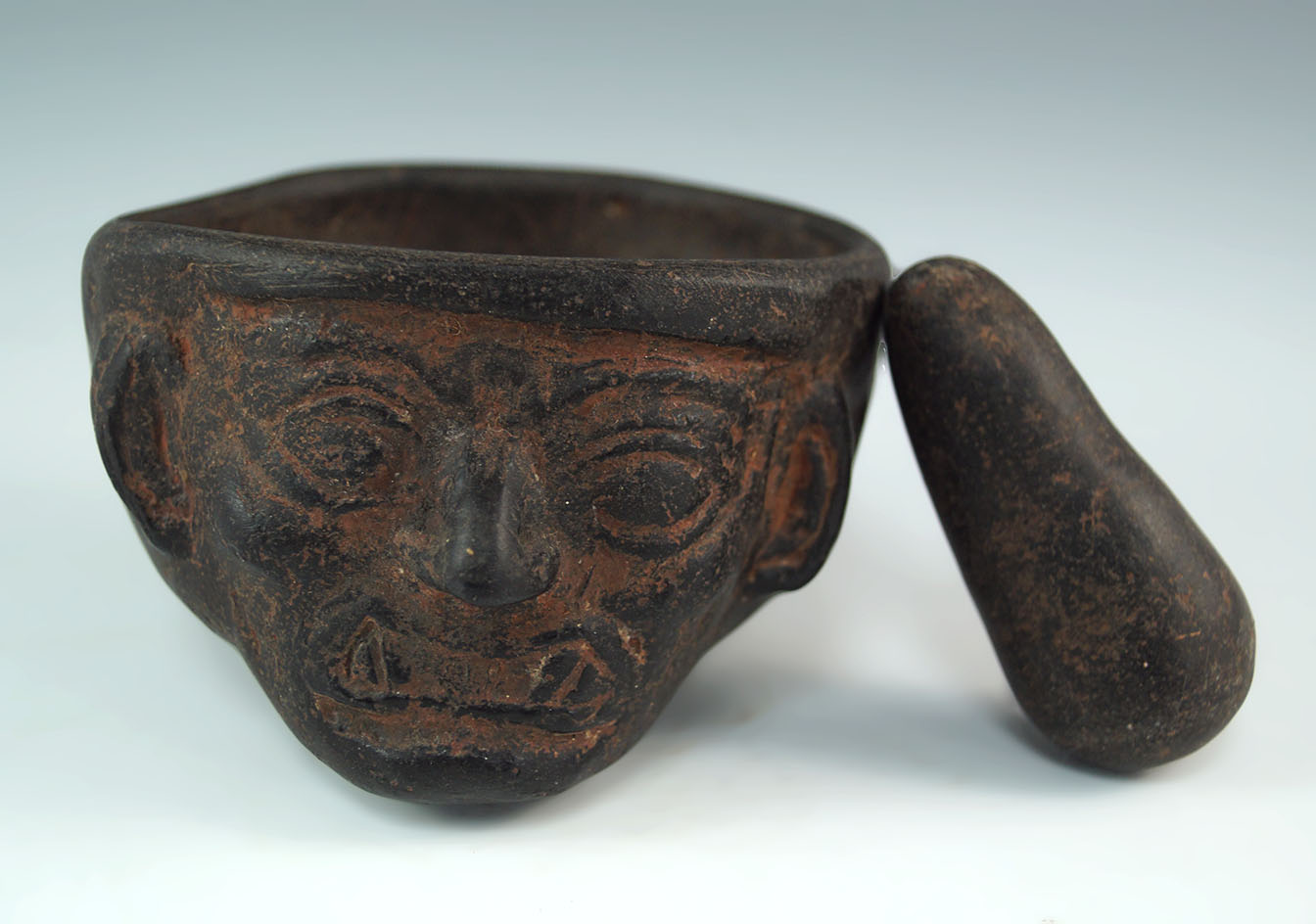 Chavin culture medicine cup with 2 faces and original pestle. Found in Peru. Circa 800 BC.