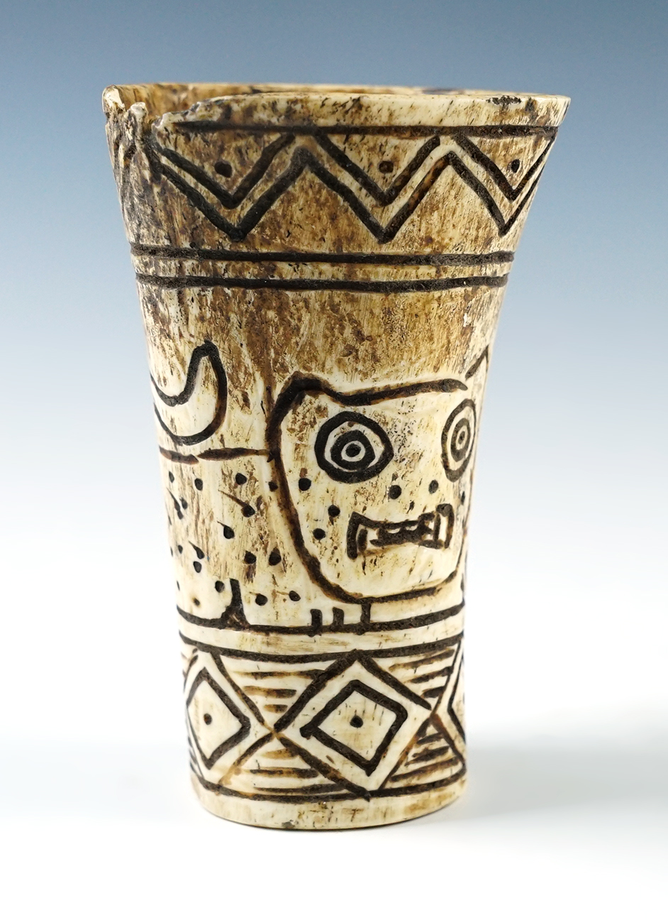 3 1/4" tall x 1 5/8" wide carved Llama bone medicine cup depicting a battle scene. 