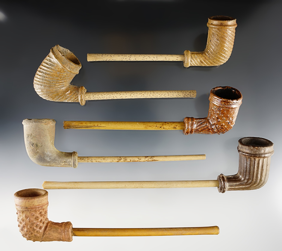 Group of six clay trade pipes with stems. Most of the pipes are in very nice condition.