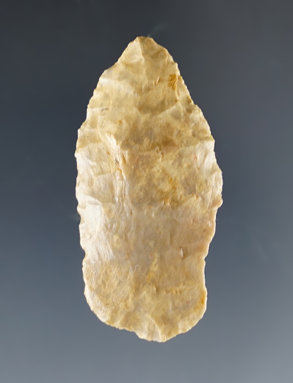 1 5/8" Paleo dart point with nicely ground lower edges in a very heavy patina. Colorado.