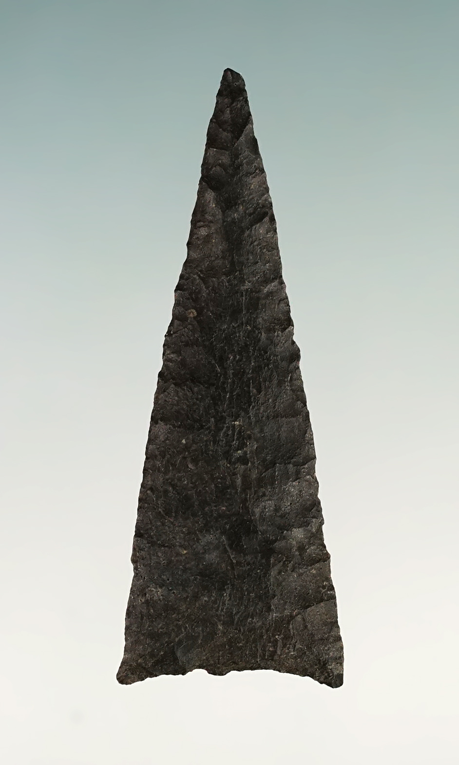 Fine 1 3/8" Triangular point found in New Mexico. Thin and well flaked.