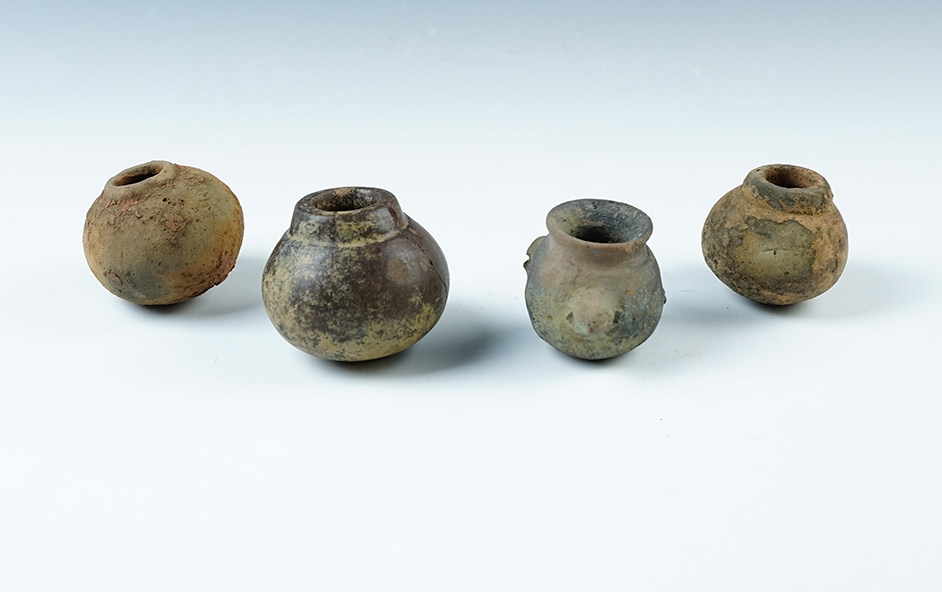 Set of four miniature pre-Columbian pottery vessels recovered in Mesoamerica. Largest is 2" wide.