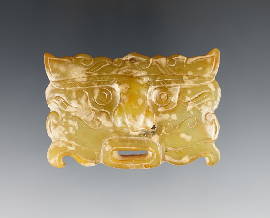 Excellent craftsmanship on this 2 1/2" wide translucent mask pendant recovered in Southeast Asia.