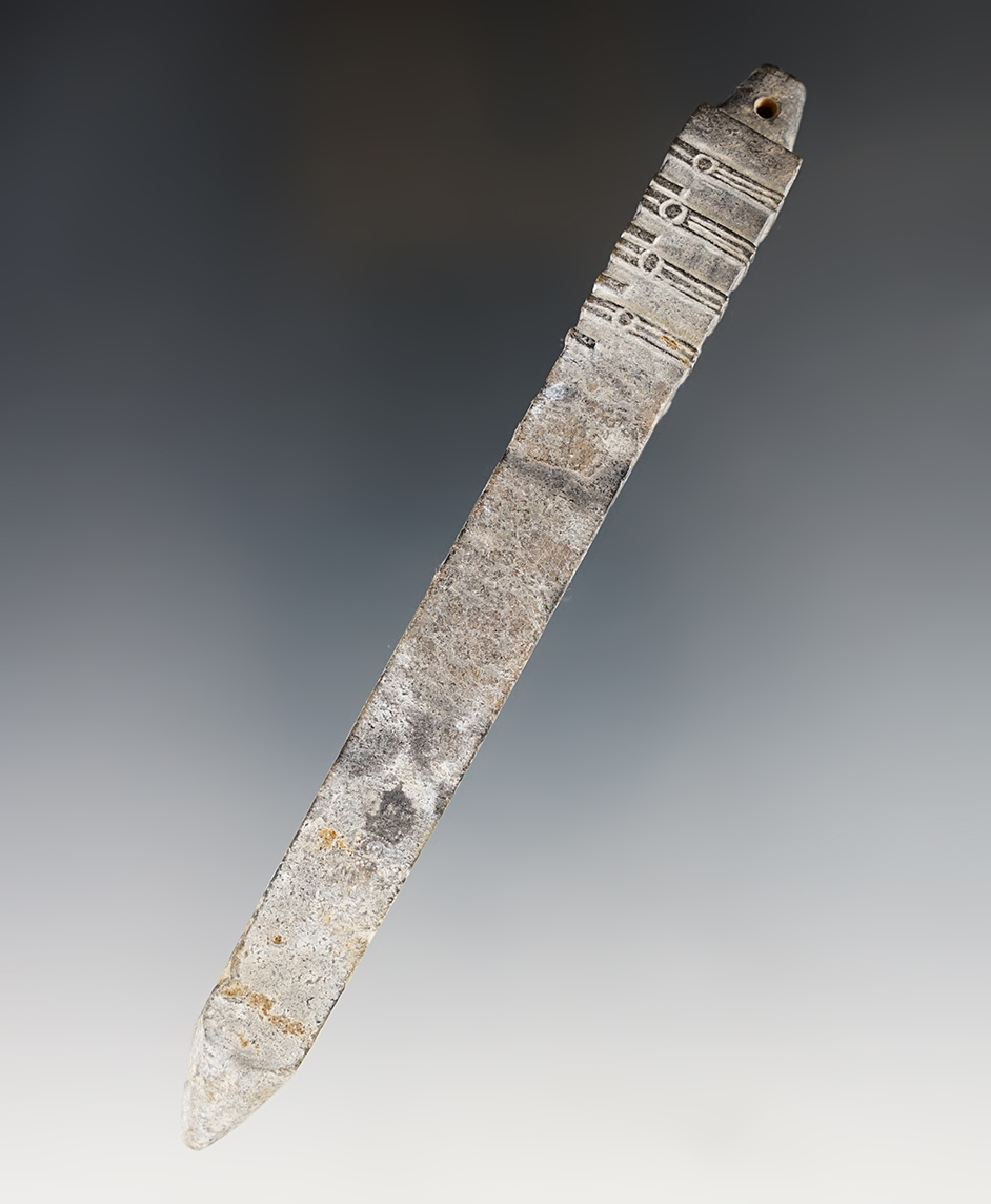 Heavily patinated 5 7/16" drilled and decorated obelisk pendant recovered in Southeast Asia.