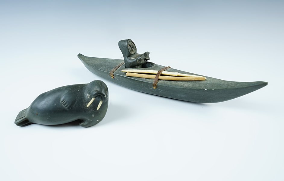 Pair of Inuit Carvings from Alaska including a 3 3/4" Walrus and a 8 3/4" Kayak w/removable figure. 