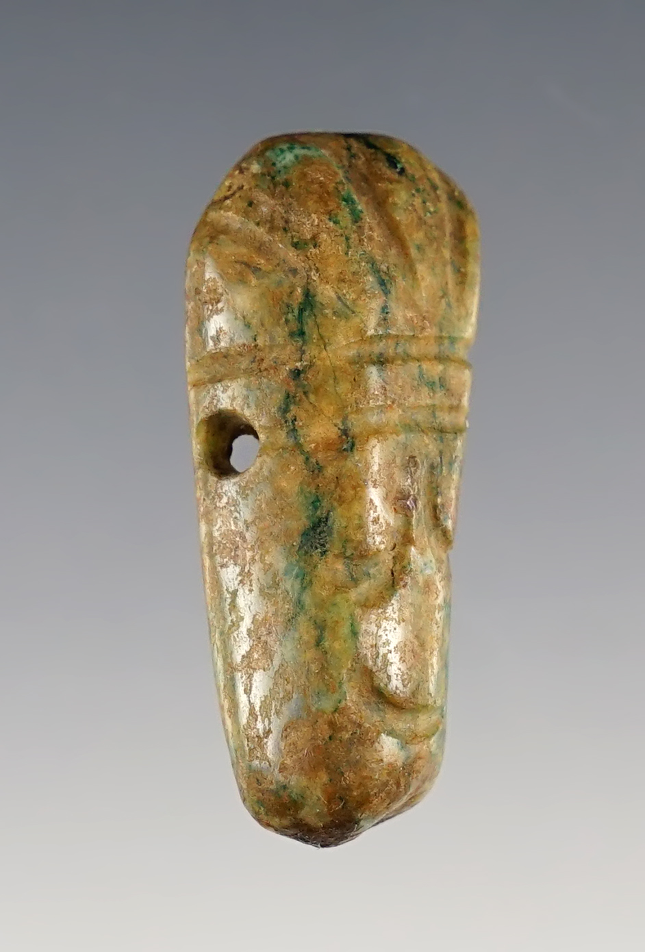 1 9/16" Head pendant,  Mixtec, Oaxaca State, Mexico, 900-1400 CE, green jade.