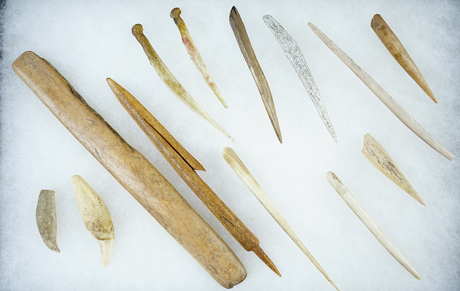 Group of 13 assorted Alaskan Bone Artifacts: 6 3/8" harpoon tip & a 7 3/4" knife handle.
