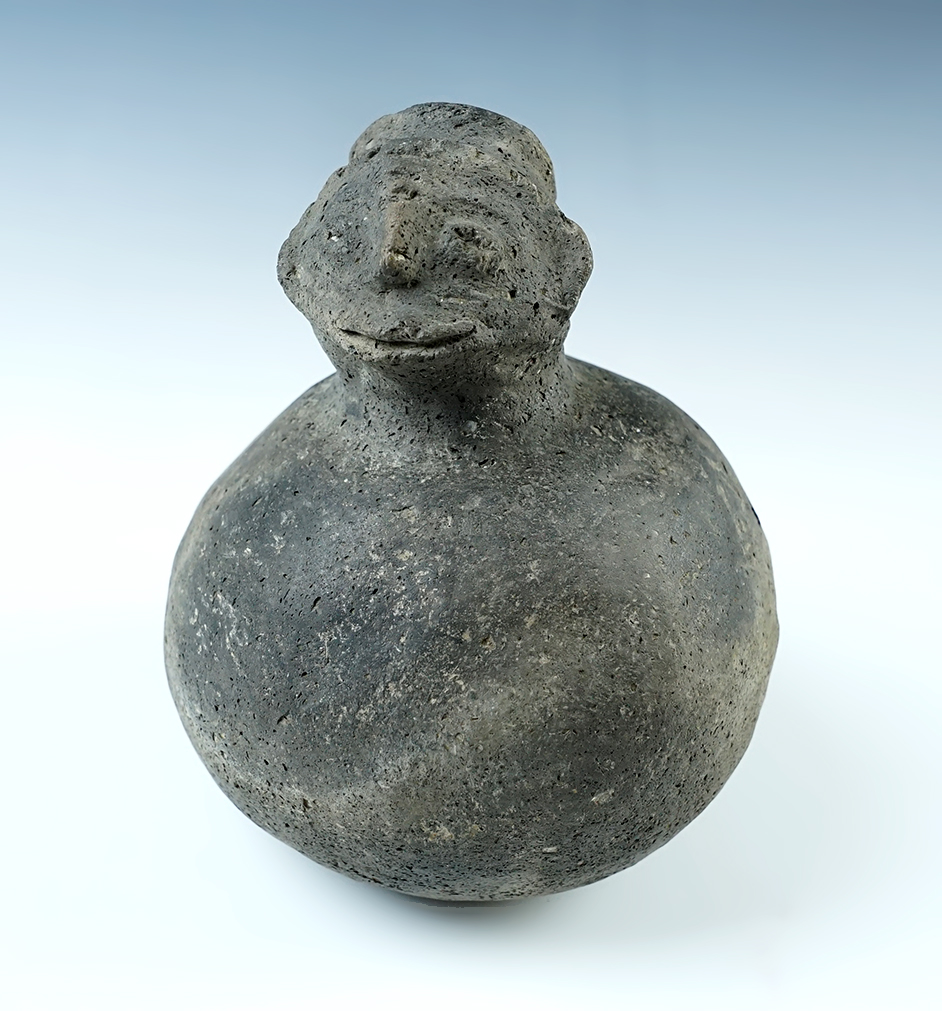 5 3/4" tall x 4 5/8" wide. Hooded Human Effigy Bottle. Recovered in Tennessee. Minor restoration.