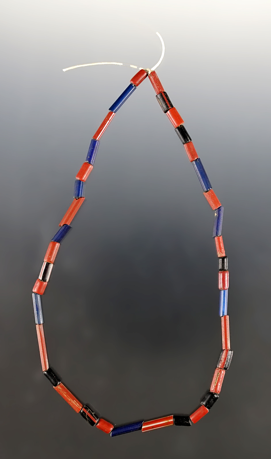 12" Strand of blue, black and red Tubular Beads. Recovered at the Dann Site, Lima, New York. 