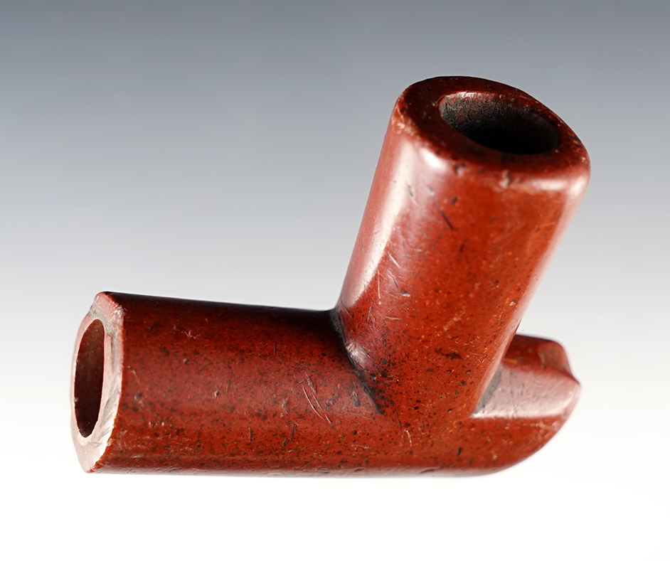 Well patinated 2 5/8" x 2 1/4" red Catlinite Elbow Pipe with 3 tally marks on elbow end.