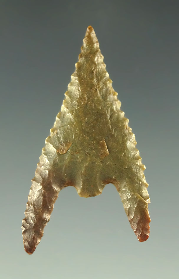 1 3/8" Gunther point with two very long barbs found in Oregon. Ex. Charles Shewey collection.