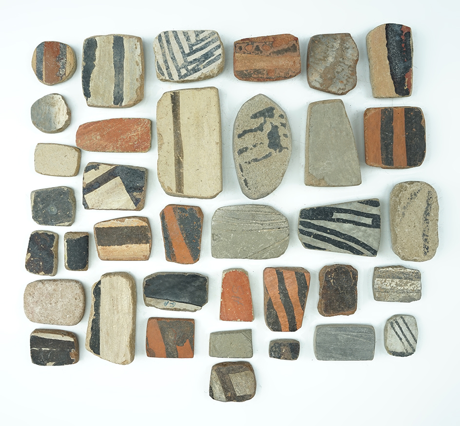 Set of 36 anciently salvaged prehistoric pottery shards sanded into various different shapes.